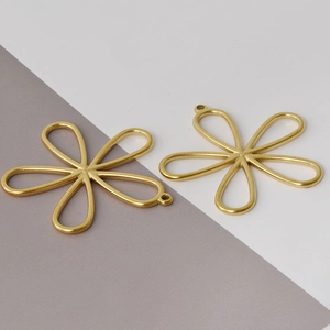 Detailed view of two gold-toned hollow flower-shaped 304 stainless steel DIY pendants