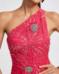 Close-up of hot pink sequin evening gown with silver floral rhinestones and feather trim