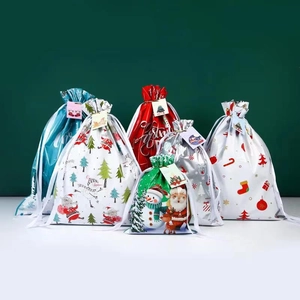 Set of six festive drawstring Christmas gift bags with Santa and snowman patterns
