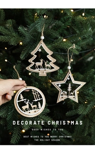 Close-up of wooden Christmas ornaments with reindeer and forest laser-cut designs