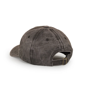 Detail of adjustable metal buckle and breathable eyelets on washed cotton baseball cap