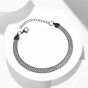 Detailed view of woven mesh titanium steel bracelet with lobster clasp and adjustable chain