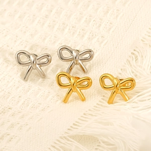 Minimalist bow-tie stud earrings in gold and silver finish with smooth metal texture