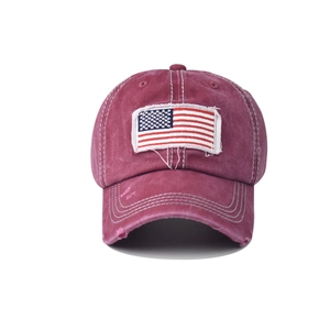 Detail of distressed cotton baseball cap with vintage flag embroidery and worn edges