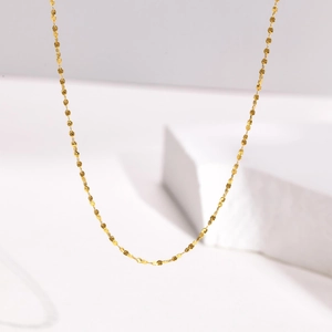 Sparkling 18k gold plated titanium steel star petal chain necklace on white pedestal