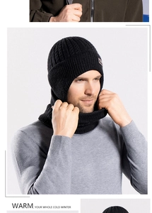 Detail of black winter knit beanie and neck warmer set with thick cable texture