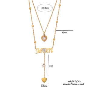 Detailed view of golden stainless steel double-layer necklace with MOM pendant and tassels