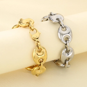Polished gold and silver stainless steel pig nose bracelets on beige display