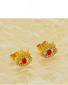 Detail of 18K gold plated evil eye stud earrings with red stone and white zircons