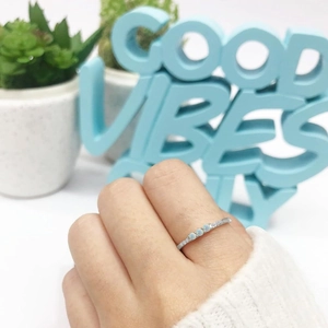Minimalist S925 sterling silver triple opal ring worn by a model on a white background