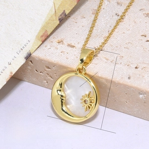 Macro shot of 18K gold plated crescent moon necklace with white shell inlay and star