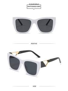 Detail of white square frame sunglasses featuring gold triangle metal hinge accents