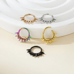 Detail of punk style stainless steel segment rings with sharp spikes in five colors