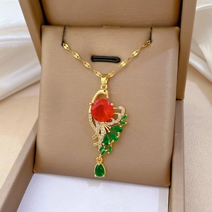 Detailed shot of peacock pendant with red gemstone and micro-inlaid green crystals