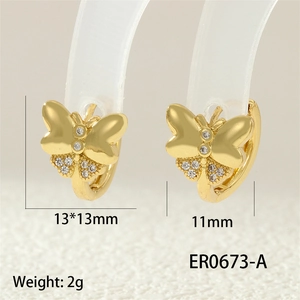 Macro view of 18K gold bow butterfly earrings with zircon details and 13x13mm dimensions