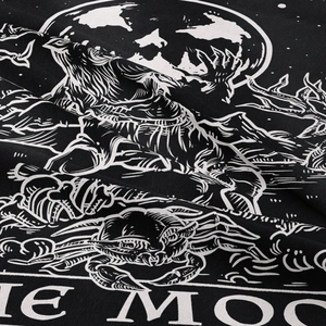 Close-up of bohemian tarot moon tapestry fabric with detailed black and white wolf prints
