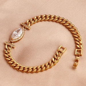 Gold-plated Cuban bracelet featuring a large marquise zircon center on a pink fabric background