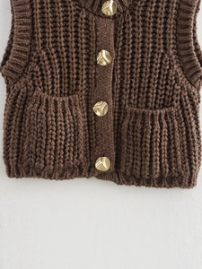 Brown chunky knit vest with cable pattern, front pockets and golden buttons detail