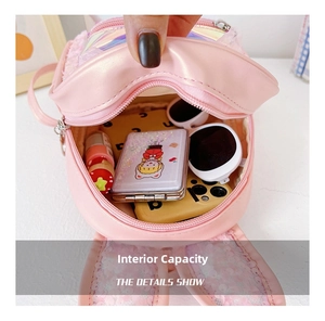 Pink toddler backpack interior detail showing storage space for sunglasses and small items