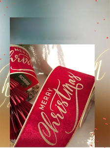 Detail of red velvet Christmas ribbon with gold Merry Christmas lettering for gift wrapping