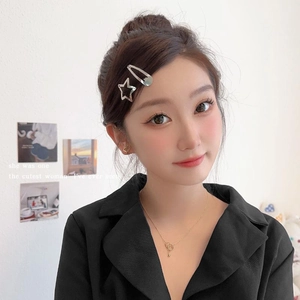 Star-shaped hair clip and heart earrings jewelry set worn by a female model