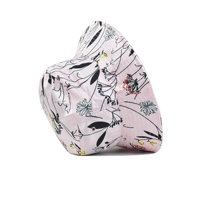 Detailed view of pink bucket hat with floral print and breathable metal eyelets