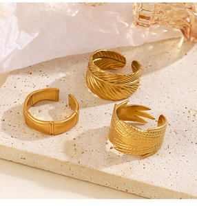 Macro detail of three 18K gold plated leaf and bamboo adjustable open rings for women
