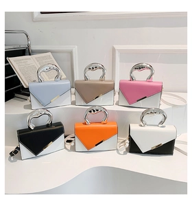 Collection of colorful leather handbags featuring modern silver liquid metal handles