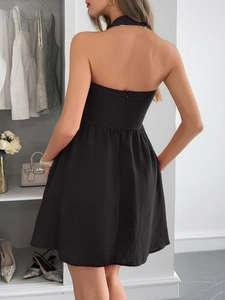 Detail view of the elegant black halter mini dress featuring a back zipper closure