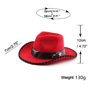 Close-up of red cowboy hat with floral embroidery and ox head emblem on black leather band