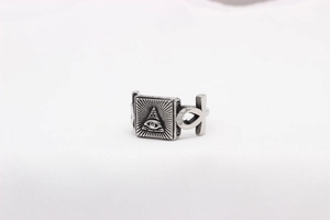 Detailed macro view of retro stainless steel ring with All-Seeing Eye and Ankh symbols