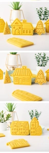 Vue détaillée de biscuits jaunes en forme de maison et de sapin avec textures gravées