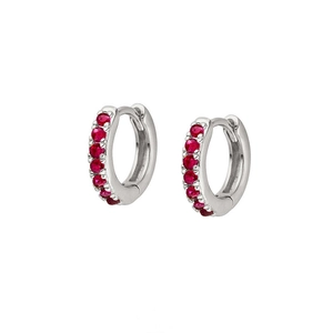 Close-up of S925 silver huggie earrings featuring micro-pave red cubic zirconia stones