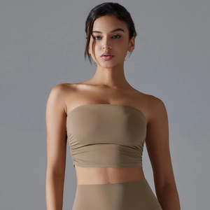 Detail of ruched side seam on high-stretch earth-tone yoga top and leggings set