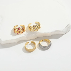 Set of four layered gold adjustable rings with heart cutouts and colorful zircon stones