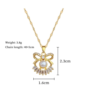Detail showing dimensions of gold bow pendant necklace with pearls and cubic zirconia