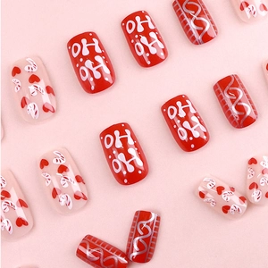 Christmas press-on nails with red and white candy cane heart patterns in short square shape