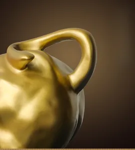 Detailed close-up of a golden bull statue tail showing fine metallic craftsmanship and texture
