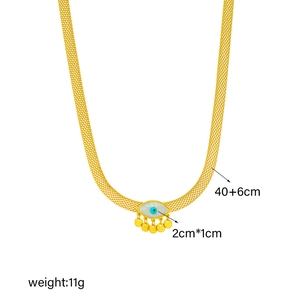 Detail of gold mesh chain necklace with blue evil eye pendant and five golden tassels