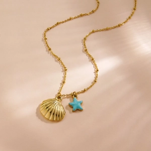14K gold-plated stainless steel necklace with shell and blue starfish pendants in sunlight