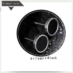 Detailed view of round stainless steel barbell earring in silver and black finish