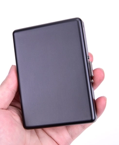 Handheld view of a sleek matte black aluminum cigarette case with rounded edges