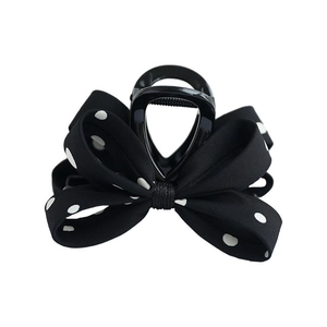 Pince à cheveux élégante à nœud papillon noir et blanc avec un motif à pois rétro