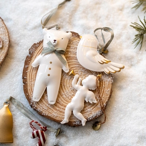 Nordic ceramic Christmas ornaments including bear and angel on rustic wood slice