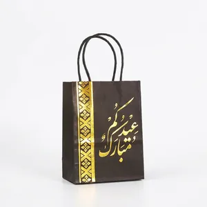 Elegant black Eid Mubarak paper gift bag with golden calligraphy and handles