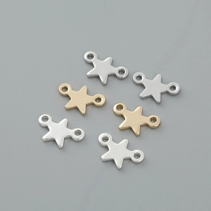 Detailed view of metal star pendants for DIY jewelry making in gold and silver finishes