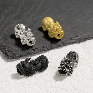 Detailed view of Pixiu charms in 18K gold, silver and black finish for DIY bracelets