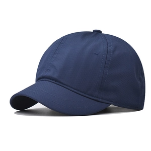 Detail view of navy blue quick-dry mesh fabric and stitching on short brim outdoor cap