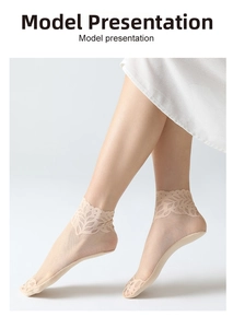 Detail of sheer mesh crew socks with French lace cuffs and leaf patterns for women