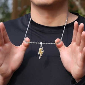Macro detail of lightning bolt pendant with yellow and white pavé cubic zirconia on rope chain
